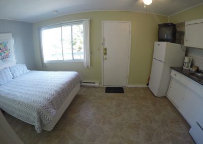 Bed and kitchen areas in Room 7 at Jasper Way Inn lodging in Clearwater, BC