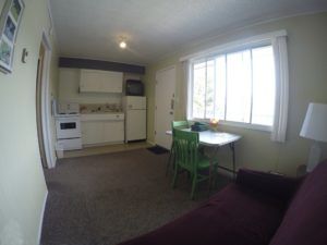 Kitchen, living, entrance and dining areas in Room 8 at Jasper Way Inn lodging in Clearwater, BC