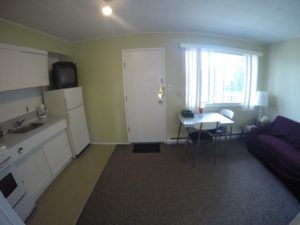 View of kitchen, living, dining and entrance area in Room 9 at Jasper Way Inn lodging in Clearwater, BC