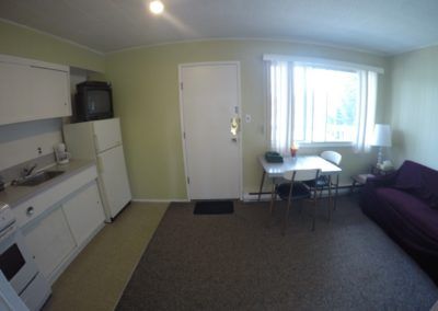 View of kitchen, living, dining and entrance area in Room 9 at Jasper Way Inn lodging in Clearwater, BC