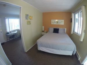Sleeping area and view of kitchen and entrance areas in Room 9 at Jasper Way Inn lodging in Clearwater, BC