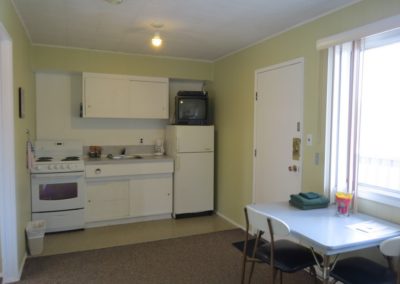Kitchen, entrance and dining in Room 9 at Jasper Way Inn lodging in Clearwater, BC